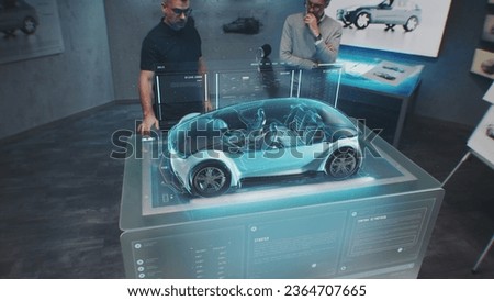 Two automotive engineers develop body of new eco-friendly electric car using futuristic augmented reality holographic automobile prototype. 3D graphics of vehicle high-tech developing. VFX animation.