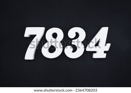 Black for the background. The number 7834 is made of white painted wood.