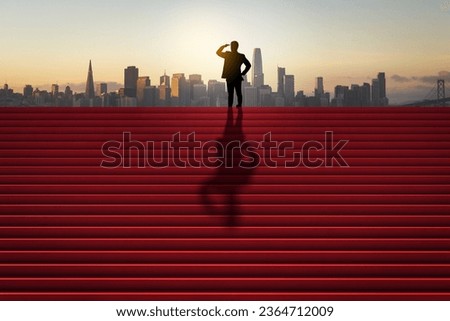 Side view of businessman silhouette looking into the distance on red stairs with shadow and city skyline in the background. Success, tomorrow, future and vision concept