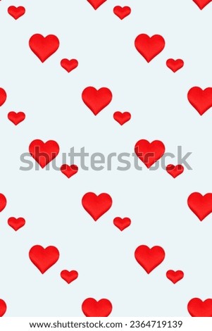 Repetitive pattern made of red hearts different sizes. Creative composition on a blue background.