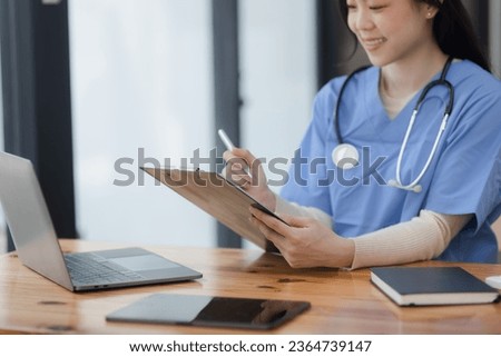 Medical doctor working with laptop and stethoscope at desk in hospital, Asian female doctor, Healthcare and medical service concept.