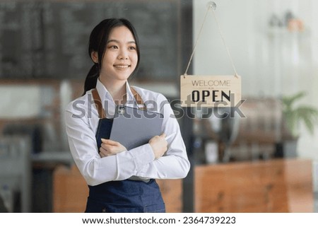 Happy smelling Asian woman owner with open sign broad and ready to service, cafe owner, Small startup business concept.