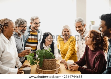 Happy multiracial friends with different ages and ethnicities having fun drinking coffee at home Royalty-Free Stock Photo #2364744685