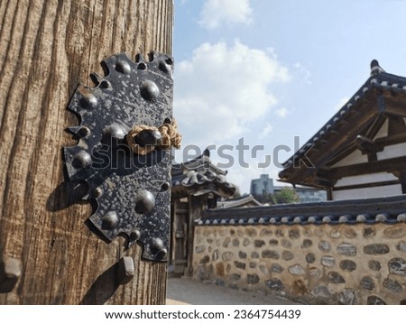 Traditional Korean Hanok Village building with old wooden door and metal lock in the afternoon in Seoul, South Korea