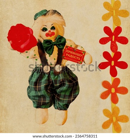 Toy clown with a porcelain face, a rose in the right hand and a card "BRING JOY" in the left hand on a vintage background with a flower ornament