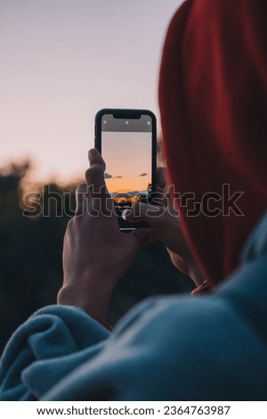 A person taking a picture of the sunset in croatia