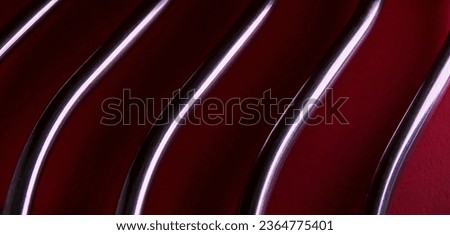 metallic rods with shadows on dark red background

