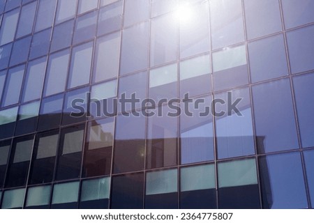 Modern building in the city with sunlight. Abstract texture and blue glass facade in modern office building., Retro stylized colorful tonal filter effect. Sunlight. High quality photo