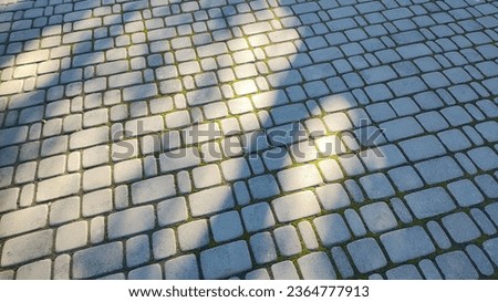  brick texture. Road made of stones. Texture of paving stones. Slow circular movement on the stones of a paved street. A sidewalk made of paving stones in a city park.