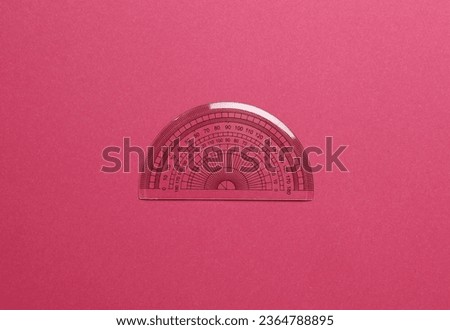 Ruler protractor on pink background