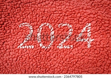 Numbers 2024 on the carpet background, red fabric texture background,Red texture.closeup.New year concept.