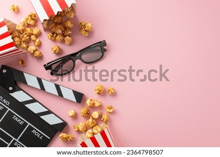 Enjoying cinema with friends: Overhead snap of cheese and caramel popcorn, 3D glasses, and a clapperboard on pastel pink, ready for your message or ad