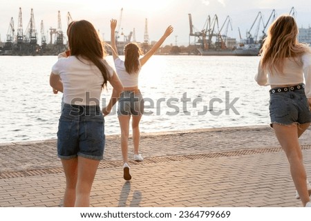 A photo of a group of friends, brimming with happiness, enjoying a day of fun and sun by the beach
