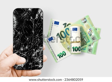 Black broken touch screen phone with cracked screen and euros. Euros is currency of Europe Union 
