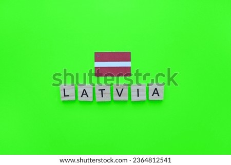 November 18, Independence Day of Latvia, flag of Latvia, minimalistic banner with the inscription in wooden letters