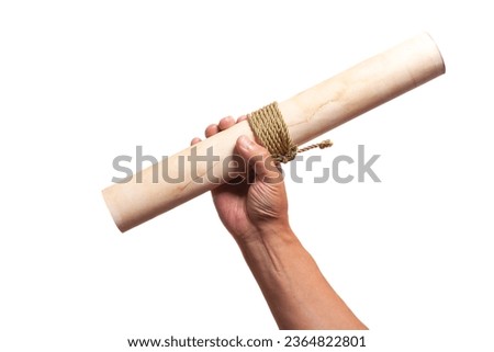 scroll of antique paper tied with a golden rope in hand. Royalty-Free Stock Photo #2364822801