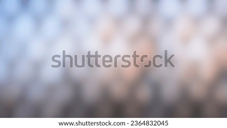 Image of an out-of-focus geometric structure with warm, bluish tones. Backgrounds and templates concept.