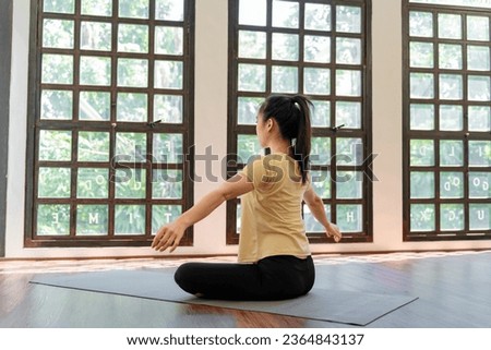 Female girl Attractive young asian woman doing stretching exercise on mat yoga Calmness and relax at gym Full body concentrated flexibility during workout.