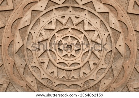 mandala texture made of cement. Background with brown mandala