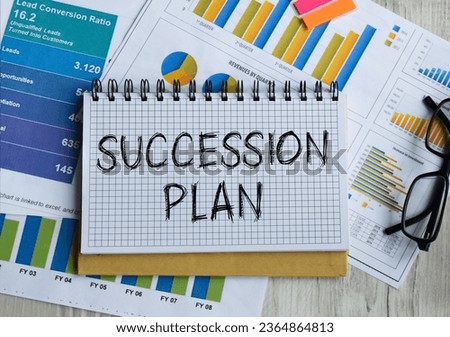 Notepad with the inscription SUCCESSION PLAN. Conceptual image, business accessories, calculator isolated on the desktop. Finance or business concept.