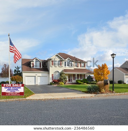 American flag Real Estate for sale open house welcome sign suburban home autumn day residential neighborhood USA blue sky clouds