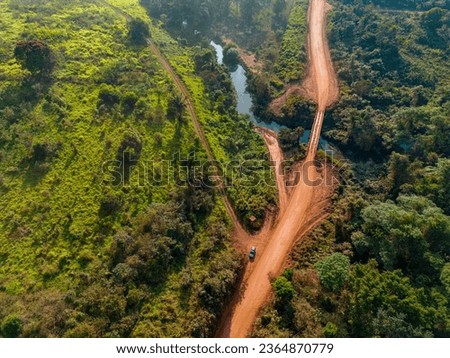 Drone shot of the famous earth road Transamazonica towards Santarém in dry season through the Amazon rainforest in northern Brazil, South America in the morning sun