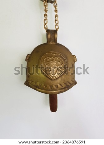 Unused copper bell previously used for bull hanging on the wall for decoration
