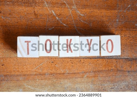 Photo of words with wooden block objects arranged into the word "TOKYO" in English
