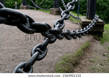 Old outdoor big durable iron chain with blurry background, security or strength or durability concept Royalty-Free Stock Photo #2364901133