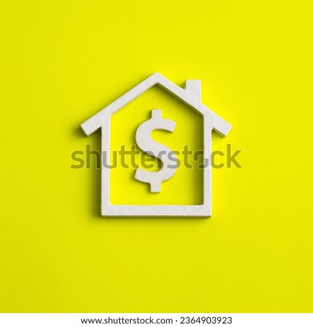 Real estate concept sale in dollars - House on yellow background