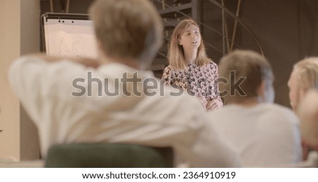 Portrait student flipchart discussing tasks expressing various opinions university seminar Intellectual exchange exploration school lesson Collegiate discourse background  Royalty-Free Stock Photo #2364910919