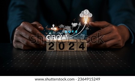 Businessman placing wooden blocks with the year 2024 AD To create a destination, a goal, for the business to grow. according to purpose business growth concept, copy space, space for text, background