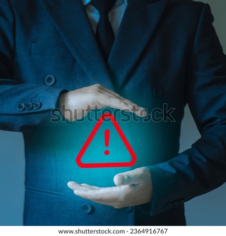 Businessman or user, programmer, holding triangle warning sign for error notification and warning, maintenance and safety concept.