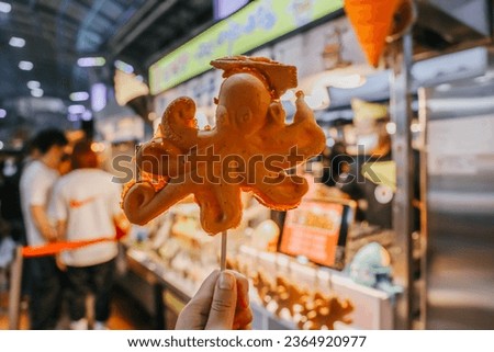 Squid shaped bread filled with cheese at the Dongmun Night Market. Royalty-Free Stock Photo #2364920977