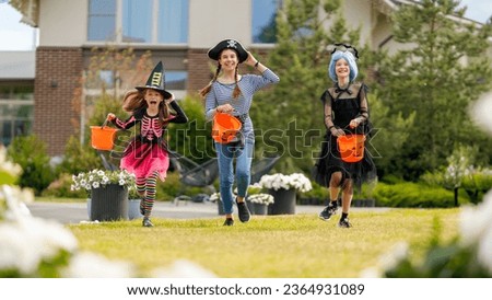 Happy kids at Halloween party. Children are wearing carnival costumes. Royalty-Free Stock Photo #2364931089