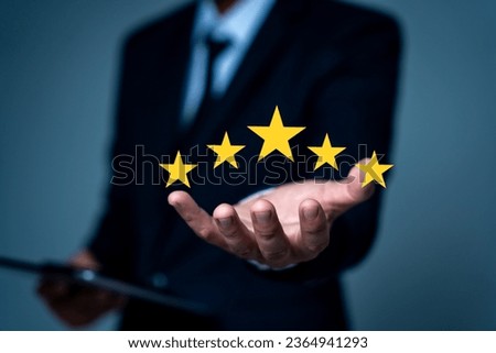 hand of customer or client holding the stars to complete five stars. with copy space. giving a five star rating. Service rating, satisfaction concept. Royalty-Free Stock Photo #2364941293