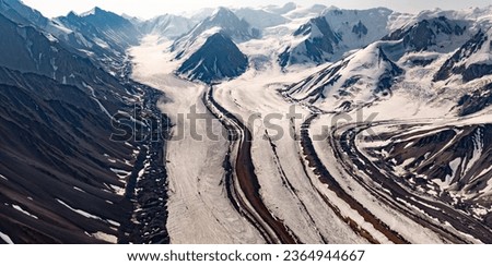 St. Elias Mountains valley filled with glacier flow and rocky glacial moraines in Kluane National Park, Yukon Territory, Canada, near Haines Junction Royalty-Free Stock Photo #2364944667