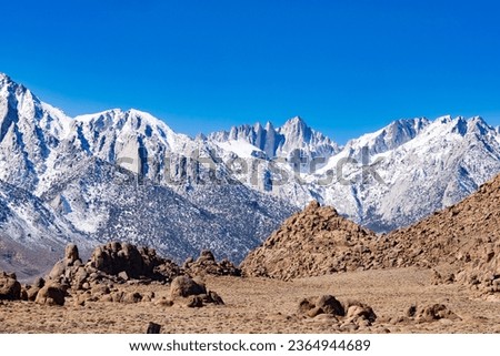 Snowy Sierra Nevada mountain range and Mount Whitney rocky Mojave Desert Alabama Hills landscape near Lone Pine, California, USA Royalty-Free Stock Photo #2364944689