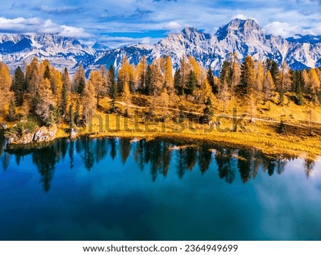 Autumn colors on Lake Federa. Dolomites from above Royalty-Free Stock Photo #2364949699