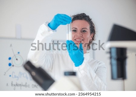 An expert using test tubes for analysis milk quality in a laboratory Royalty-Free Stock Photo #2364954215