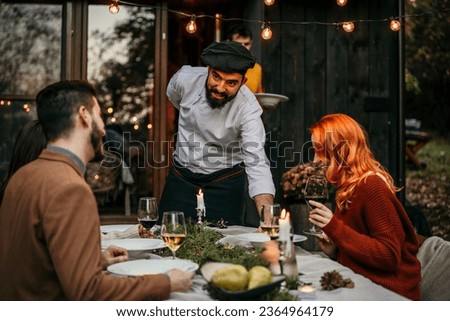 The chef serves food and curates an unforgettable culinary experience for the people.	 Royalty-Free Stock Photo #2364964179
