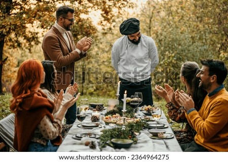 The chef serves food and curates an unforgettable culinary experience for the people.	 Royalty-Free Stock Photo #2364964275