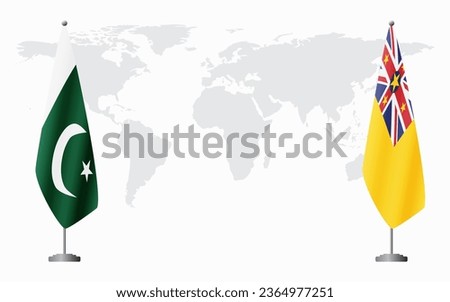 Pakistan and Niue flags for official meeting against background of world map.