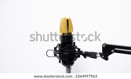 
A Gold-black studio microphone for recording sound isolated on white background.