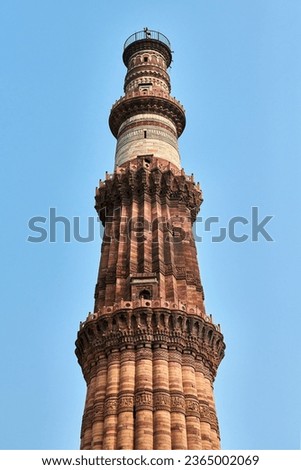 Qutb Minar minaret tower part Qutb complex in South Delhi, India, big red sandstone minaret tower landmark popular touristic spot in New Delhi, ancient indian architecture of tallest brick minaret Royalty-Free Stock Photo #2365002069