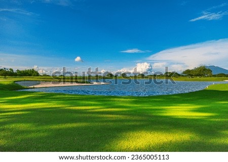 a picture of a golf course with warm colors
