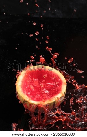 water splash of watermelon on black background