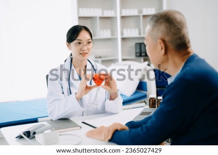 Serious Asia female doctor using clipboard is delivering great news talk discuss results or symptoms with female patient in clinic or hospital office.
