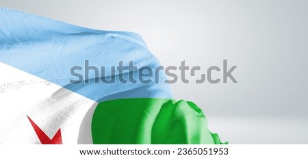 Djibouti national flag cloth fabric waving on beautiful light grey Background.