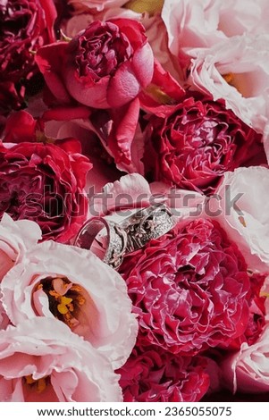                         wedding rings on a background of pink roses       